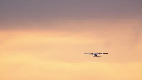 Propeller Plane Flying at Sunset Stock Footage 334436825