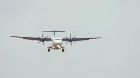 Propeller plane gently approaching for landing with gear extended. Aircraft Stock Footage 316590516
