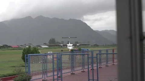 Propeller Plane Landing on Grass Runway in Peru Stock Footage 219765890