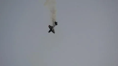 Propeller plane performing aerobatic maneuvers with smoke trail Stock Footage 340938773