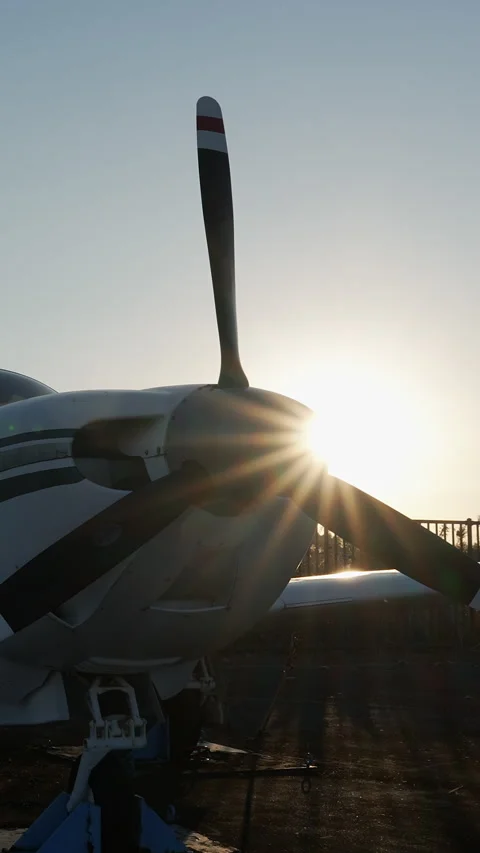 Propeller plane on runway at sunset in vertical orientation. Stock Footage 329458896