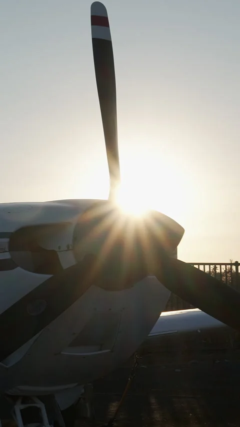 Propeller plane silhouette with sunburst at sunset vertical. Stock Footage 329458908
