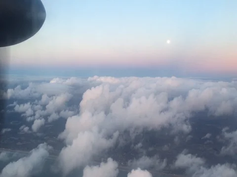 Propeller Plane Soars above the clouds amidst a clear blue sky (4K) 動画素材 79796380