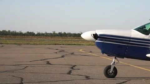 The propeller plane starts. Preparing for the flight. The working engine of the Stock Footage 153490498