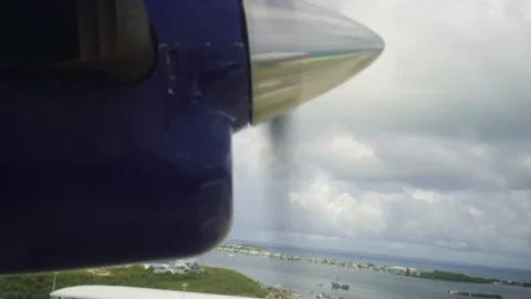 Propeller of small plane flying over island Stock Footage 168775216