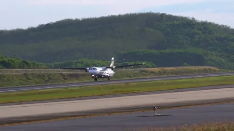 Propeller, twin-engine aircraft rolls on the runway. Close-up. Day. Airfield Video stock 72321453
