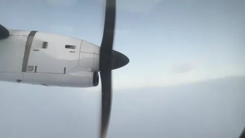 A propellerdriven aircraft cuts through clouds in the sky Stock Footage 267790492