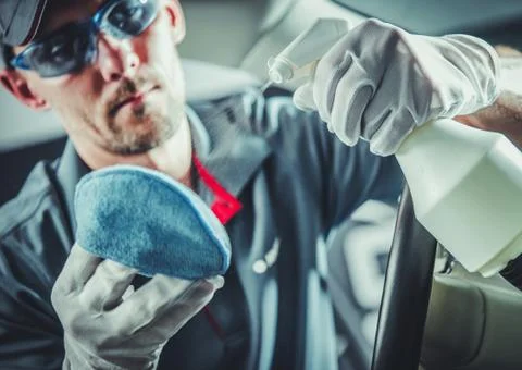 Proper Car Interior Cleaning Detergent in Mens Hand. Photos