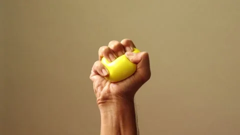 Proper tutorial to squeeze a stress ball to reduce stress during tough times. 動画素材 133051585