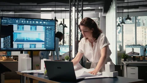 Property developer finalizing plans for land acquisition in modern office space Stock Footage 316646561