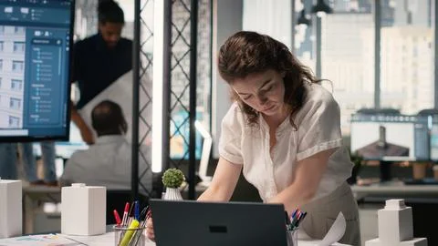 Property developer finalizing plans for land acquisition in modern office space Stock Photos