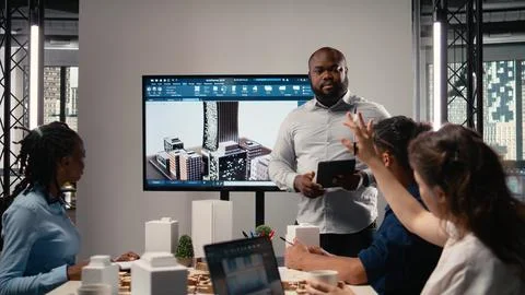 Property developer leads the planning session with 3D models for details Stock Photos