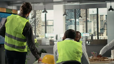 Property developers and architects in a business meeting reviewing blueprints Stock Footage 320029991