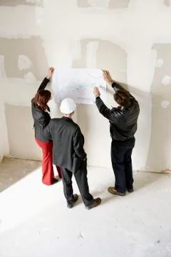 Property developers discussing blueprint Stock Photos