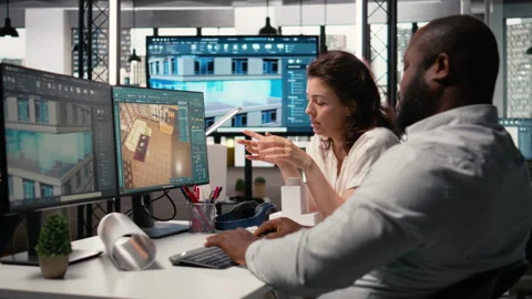Property development diverse team manages urban projects with digital blueprints Stock Footage 316795246