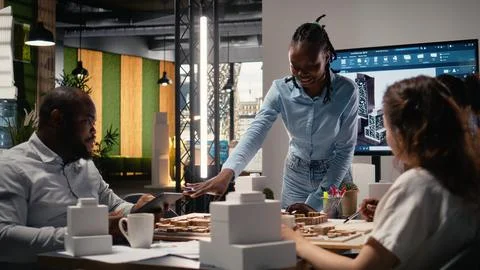 Property development team evaluating 3D models structural layout Stock Photos