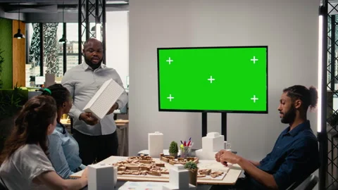 Property engineers team study architectural blueprints with a mockup on TV Stock Footage 316645496
