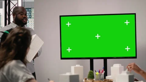 Property engineers team study architectural blueprints with a mockup on TV Stock Footage 316793404
