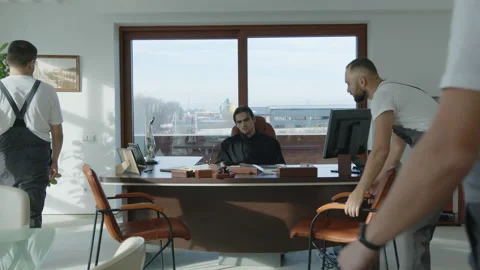 Property inventory. Workers take all things from the office for debts. Bose sits Stock Footage 136595586