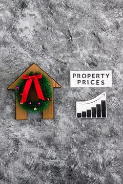 Property prices text and graph with stats going up next to cardboard house .. Stock Photos