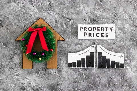 Property prices text and graph with stats going up and down next to cardboa.. Stock Photos