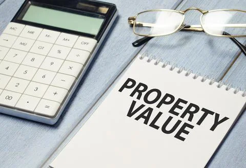 Property Value text on white notebook with calculator Stock Photos