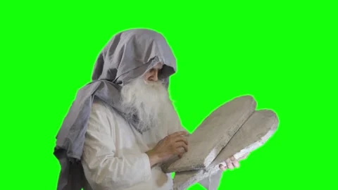 Prophet Moses holds the tablets with the ten commandments on a green Stock Footage 265250607