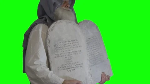Prophet Moses holds the tablets with the ten commandments on a green Stock Footage 265251061