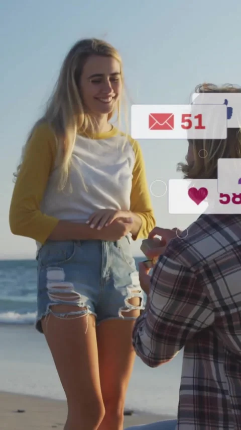 Proposing on beach, couple surrounded by social media notifications animation Stock Footage 319883138