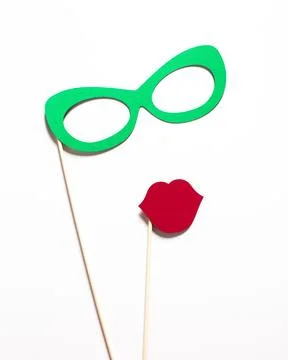 Props for a fun photo booth backdrop featuring green glasses and red lips on Stock Photos