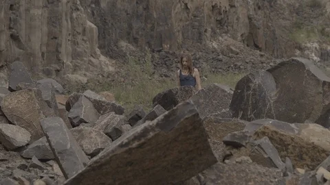 ProRes 4:2:2 log, slow motion footage. Young woman walking in basalt career. Video stock 109481820