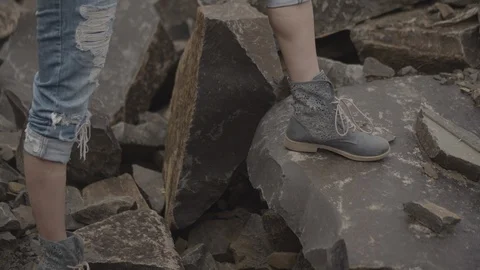 ProRes 4:2:2 log, slow motion footage. Young woman walking in basalt career. Stock Footage 109486119