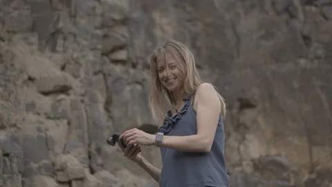 ProRes 4:2:2 log, slow motion footage. Young woman walking in basalt career. Stock Footage 109505819