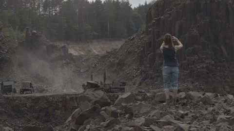 ProRes 4:2:2 log, slow motion footage. Young woman walking in basalt career. Stock Footage 109525920