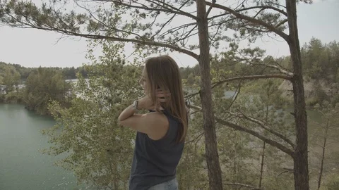 ProRes 4:2:2 log, slow motion footage. Young woman walking in the wood near lake Stock Footage 109545141