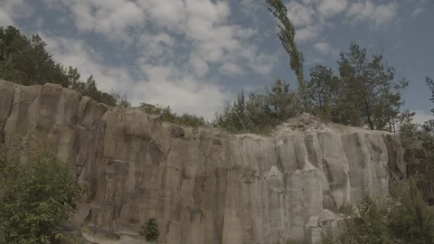 ProRes 4:2:2 log, slow motion footage. Young woman walking in basalt career. Video stock 109584631