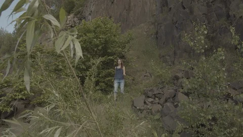 ProRes 4:2:2 log, slow motion footage. Young woman walking in basalt career. Video stock 109603869