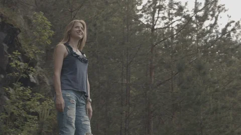 ProRes 4:2:2 log, slow motion footage. Young woman walking in basalt career. Stock Footage 109604268