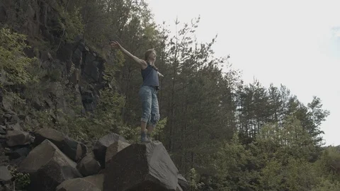 ProRes 4:2:2 log, slow motion footage. Young woman walking in basalt career. Stock Footage 109605761