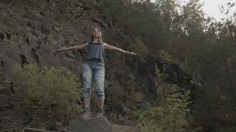 ProRes 4:2:2 log, slow motion footage. Young woman walking in basalt career. Stock Footage 109606379