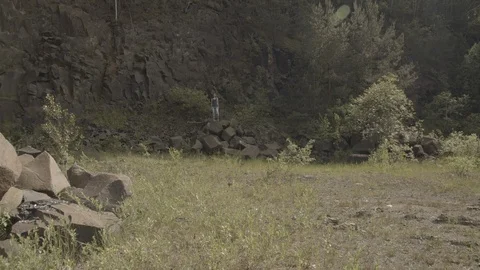 ProRes 4:2:2 log, slow motion footage. Young woman walking in basalt career. Stock Footage 109607138