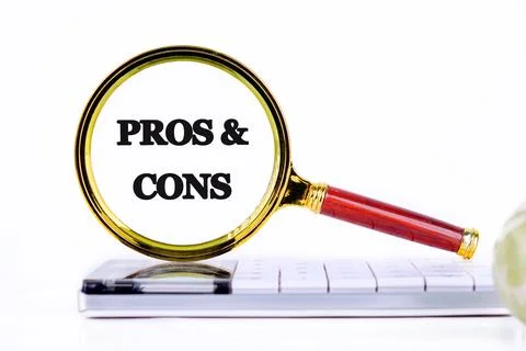 PROS and CONS message through a magnifying glass, close-up on a calculator in Stock Photos