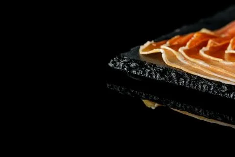 Prosciutto on a black background 写真素材