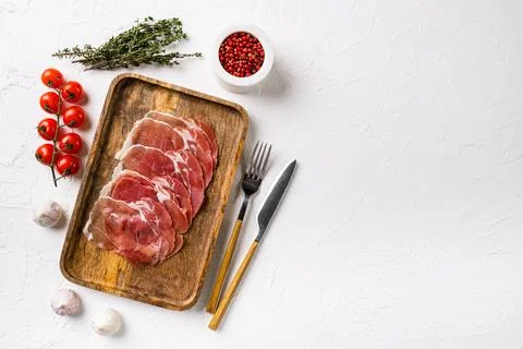 Prosciutto crudo, italian salami, parma ham, on white stone table background, Stock Photos