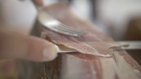 Prosciutto Cutting with a Knife in Slow Motion Stock Footage 86335157
