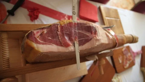 Prosciutto dry-cured ham being sliced with long knife Stock Footage 119393324