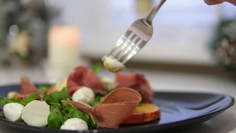 Prosciutto mozzarella arugula, Persimmon salad Traditional Italian antipasti in Stock Footage 302672877