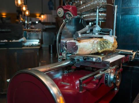 Prosciutto on an old machine Stock Photos