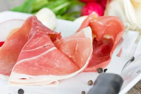 Prosciutto on plate Stock Photos