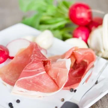 Prosciutto on plate Stock Photos